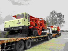 several trucks are lined up in a parking lot and one of them has a tiger on the front