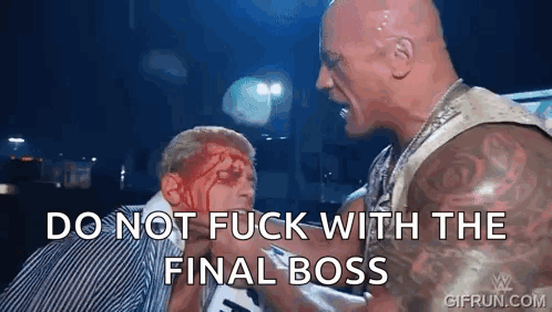 a man with blood on his face is standing next to another man with blood on his face .