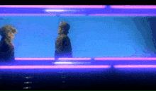 a blurry picture of two people standing in front of a blue wall with neon lights .