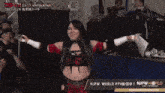 a woman stands in front of a njpw world banner