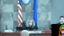 a judge sits at a desk with a sign that says mary williams