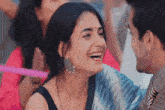 a man and a woman are smiling at each other and laughing .