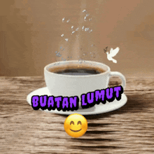 a cup of coffee on a saucer with the words buatan lumut