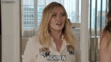 a woman wearing a white shirt with tigers on it is talking to another woman .