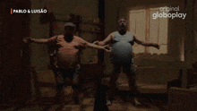 a group of people are dancing in front of a light that says pablo & luisao on the bottom