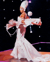 a woman in a white dress is dancing on a stage with tumblr written below her