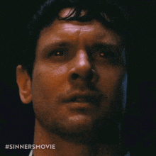 a close up of a man 's face with the hashtag #sinnersmovie visible