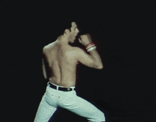 a man without a shirt is standing on a stage
