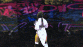 a woman stands on a stage in front of a wall that has the word rnk on it