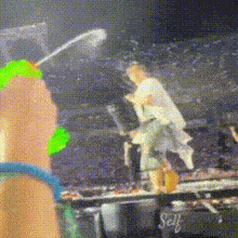 a blurry picture of a person holding a green water gun