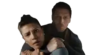 a man is holding a woman in his arms and she is looking at the camera