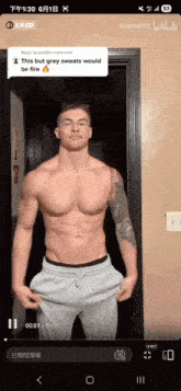 a shirtless man is standing in front of a door with a comment that says this but grey sweats would be fire on it
