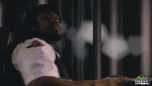 a man in a white shirt is behind bars with the words friday tales on the bottom