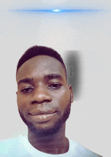 a man with a beard wears a white shirt with the letter g on the bottom