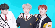 three young men are posing for a picture with one wearing a sweater that says real