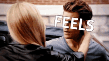a woman touching a man 's face with the word feels written on the screen