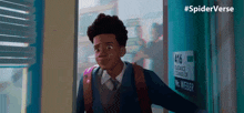 a boy with a backpack is standing in front of a sign that says mrs weber