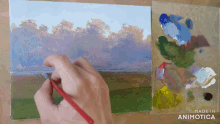 a person is painting a landscape with the words made in animatica on the bottom right