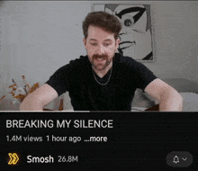 a man sitting in front of a screen that says breaking my silence on it