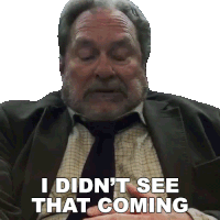 a man in a suit and tie is saying " i didn 't see that coming "