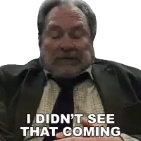a man in a suit and tie is saying " i didn 't see that coming "
