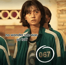 a woman wearing a green jacket with the number 067 on it