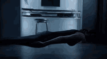 a person laying on the floor in front of a desk