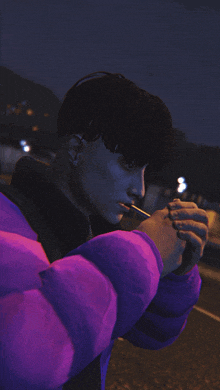 a man wearing a purple jacket is lighting a cigarette