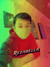 a boy wearing a face mask with the name rezabella written on his shirt