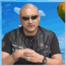 a man wearing sunglasses and a black shirt is standing in front of a hot air balloon .