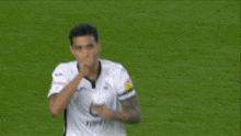 a blurry picture of two soccer players with one wearing the number 27