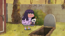 a girl holding a doll in front of a grave with the letters xxx on the wall