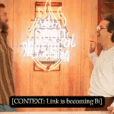two men talking in front of a neon sign that says context link is becoming bi