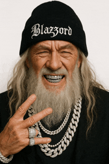 a man with a beard wears a black beanie that says blazord on it