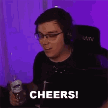 a man wearing glasses and headphones is holding a glass of water and says cheers .