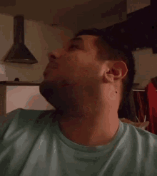 a man with a beard is laughing with his mouth open