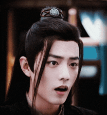 a close up of a young man 's face with a very surprised look on his face