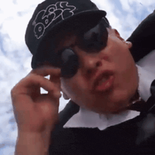 a man wearing sunglasses and a hat that says rbs on it