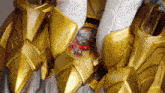 a close up of a gold armor with a sticker that says ' knight '