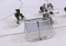 a hockey player in a green jersey with the number 21 on the back