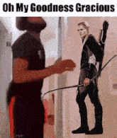 a man standing next to a woman holding a bow and arrow with the words oh my goodness gracious above him