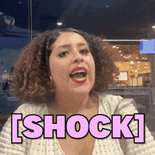 a woman with a surprised look on her face and the word shock above her