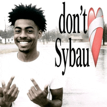 a man giving the middle finger in front of a sign that says " do n't sybau "