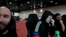 a man wearing a hooded jacket with the word adidas on the side