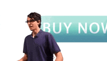 a man is standing in front of a buy now button