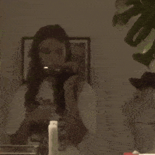 a woman is taking a selfie with a camera .