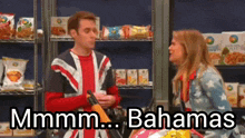 a man and a woman are standing in front of a shelf of food and the words bahamas are above them