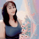 a woman stands in front of a window with flowers and butterflies and a tank top that says brooklyn
