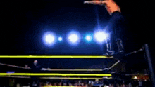 a blurry picture of a boxing ring with a blue background