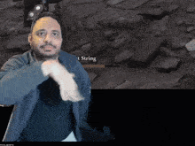 a man stands in front of a screen that says ' t string '